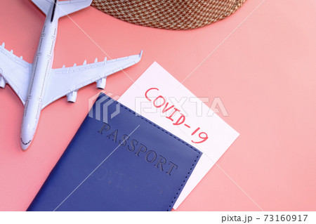 protective mask, airplane and blue color passport on table  73160917