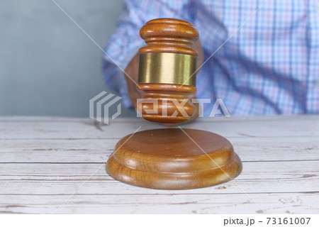close up of person's hand striking the gavel. close up of person's hand striking the gavel. 73161007