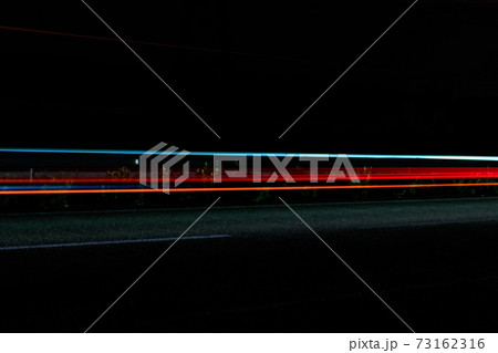 Traffic light trails on a highway at night 73162316