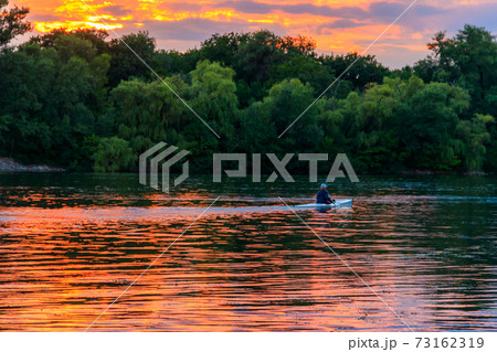 Man kayaking along the Dnieper river at sunset 73162319