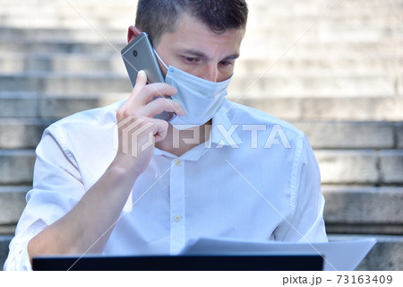 Young financial analyst in mask workin Young financial analyst in mask workin 73163409