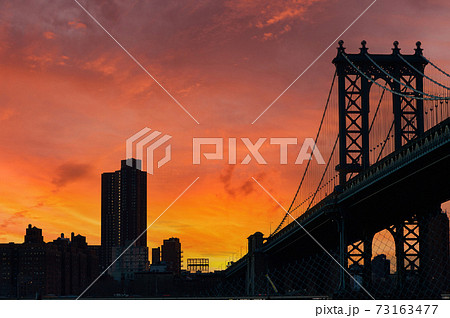 Manhattan Bridge and skyline silhouette view from Brooklyn at sunset Manhattan Bridge and skyline silhouette view from Brooklyn at sunset 73163477
