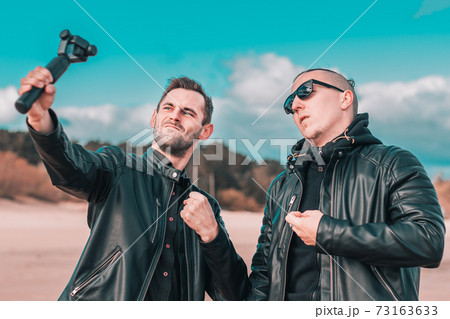 Two Handsome Guys Making Selfie Using Action Camera Two Handsome Guys Making Selfie Using Action Camera 73163633