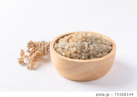 Cooked brown quinoa seeds in a wooden bowl Cooked brown quinoa seeds in a wooden bowl 73168144