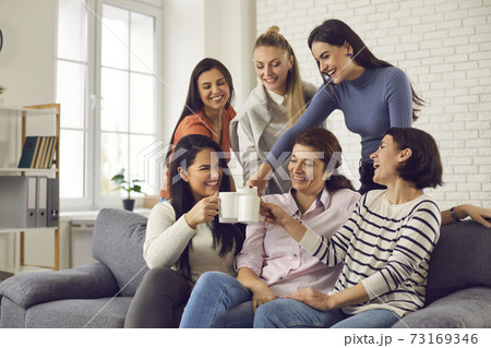 Group of happy young women drinking coffee, laughing and enjoying fun time together Group of happy young women drinking coffee, laughing and enjoying fun time together 73169346