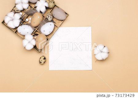 Easter eggs on beige pastel background with space for text. Flat lay image composition, top view. Easter eggs on beige pastel background with space for text. Flat lay image composition, top view. 73173429