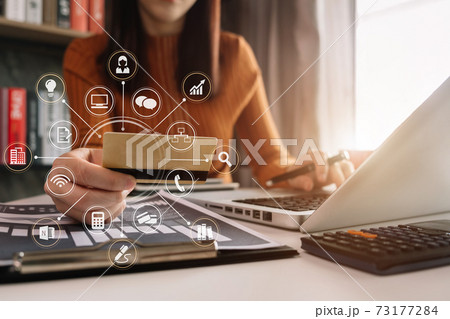 Business women hold credit cards, conduct financial transactions via tablets and data documents, put on the desk in the morning.  73177284