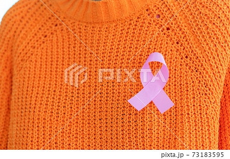 close up of woman in knitted sweater with pink breast cancer awareness ribbon close up of woman in knitted sweater with pink breast cancer awareness ribbon 73183595