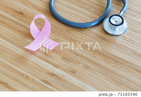 Pink ribbon and stethoscope on wooden background, closeup. Cancer concept Pink ribbon and stethoscope on wooden background, closeup. Cancer concept 73183596