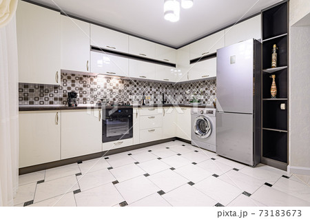 Brown and white modern kitchen interior Brown and white modern kitchen interior 73183673