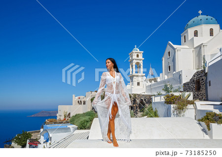 Beautiful woman in white in Santorini 73185250
