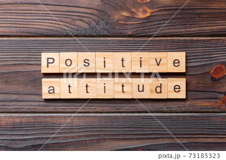 Positive Attitude word written on wood block. Positive Attitude text on cement table for your desing, concept Positive Attitude word written on wood block. Positive Attitude text on cement table for your desing, concept 73185323