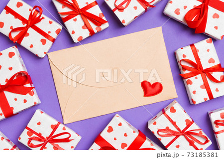 Top view of colorful valentine background made of craft envelope, gift boxes and red textile hearts. Valentine's Day concept 73185381