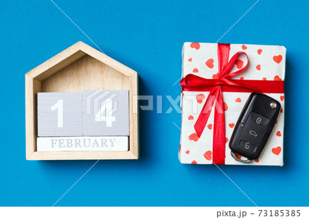 Top view of car key on a gift box with red hearts and festive calendar on colorful background. The fourteenth of february. Present for Valentine's Day concept Top view of car key on a gift box with red hearts and festive calendar on colorful background. The fourteenth of february. Present for Valentine's Day concept 73185385