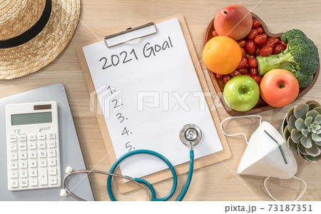 2021 New Year Goals in new normal lifestyle, work-life balance with face mask safety awareness from covid-19, healthy food, good heart health, blank resolution list on white paper medical clipboard 2021 New Year Goals in new normal lifestyle, work-life balance with face mask safety awareness from covid-19, healthy food, good heart health, blank resolution list on white paper medical clipboard 73187351