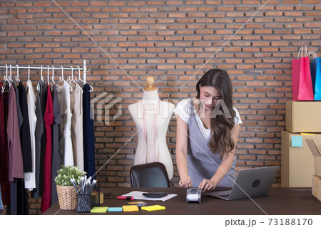 Young woman tailor with laptop is answering emails, Business woman entrepreneurial success . Sales Online Parcel delivery Young woman tailor with laptop is answering emails, Business woman entrepreneurial success . Sales Online Parcel delivery 73188170