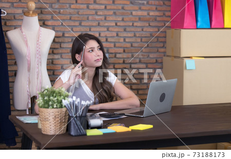 Young business woman working selling online. Surprise and shock face of asian woman success on making big sale of his online store. Online shopping Young business woman working selling online. Surprise and shock face of asian woman success on making big sale of his online store. Online shopping 73188173