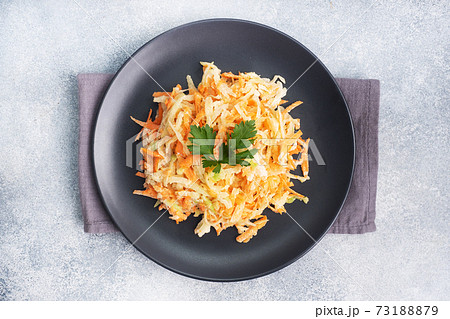 Salad of fresh grated carrots and green radish with sauce Copy space Salad of fresh grated carrots and green radish with sauce Copy space 73188879
