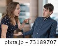 Jealousy hysterical wife is shouting and blaming her husband. 73189707