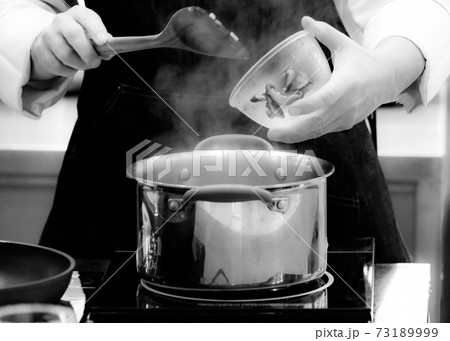 Chef cooking in a kitchen, chef at work, Black and White. Chef cooking in a kitchen, chef at work, Black and White. 73189999
