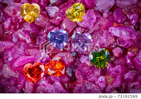 colorful diamonds heart shaped are on raw gemstones 73191569