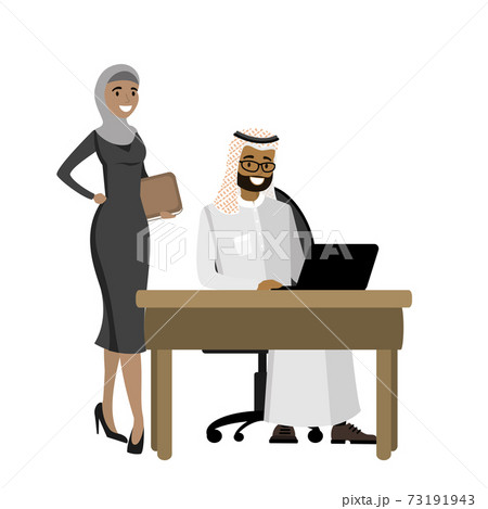 Arabic businessman working at a laptop and business woman standi 73191943