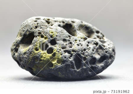 Smoke whirling around small meteorite stone 73191962