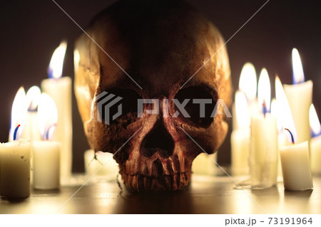 Human skull in candle light closeup Human skull in candle light closeup 73191964