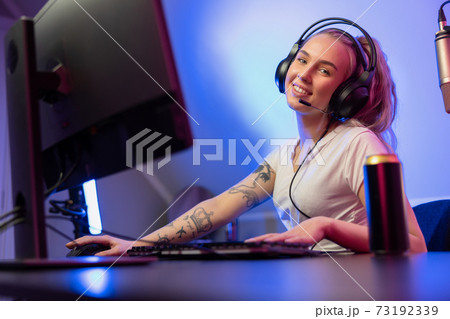 Smiling e-sport gamer girl vlogging and plays online video game on PC Smiling e-sport gamer girl vlogging and plays online video game on PC 73192339