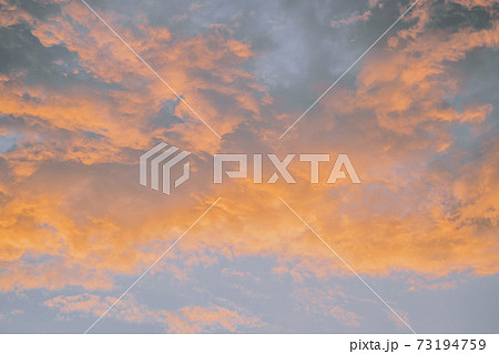 Celestial World concept. Fiery orange colorful natural bright dramatic sunset sky with clouds. Background natural color of evening cloudscape panorama. Ideal for design wallpaper Celestial World concept. Fiery orange colorful natural bright dramatic sunset sky with clouds. Background natural color of evening cloudscape panorama. Ideal for design wallpaper 73194759
