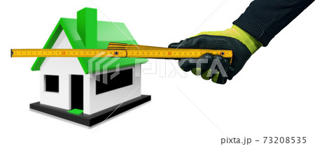 Gloved Hand Holding a Wooden Folding Ruler with a Model House on Background 73208535
