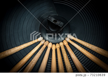 Wooden Drumsticks on a Black Cymbal of an Electronic Drum Kit 73210639