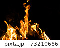 Fire flames on a black background. Abstract fiery texture. Realistic fire flames burn movement frame. Texture for Design. The texture of fire. Fire flames background. Blazing campfire. Sensitive 73210686