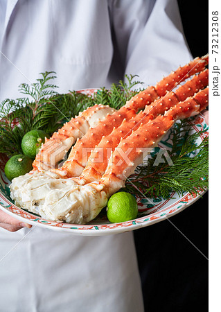 ボイルたらばがにを手に持つ板前 73212308