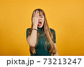 Covering eyes with hand but peeking through fingers. My eye see everything. 73213247