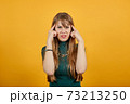 Headache grimacing pain holds the back of neck indicating location. Fatigue 73213250