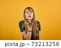 Sending sweet air kiss blowing red lips stretching hand for taking selfie 73213256