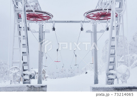 upper station of the ski lift on a snow-covered hilltop among frosty trees upper station of the ski lift on a snow-covered hilltop among frosty trees 73214065
