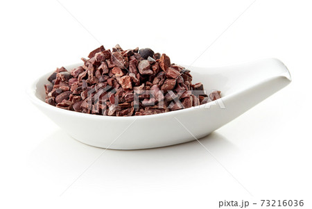 Cacao nibs in porcelain spoon Cacao nibs in porcelain spoon 73216036