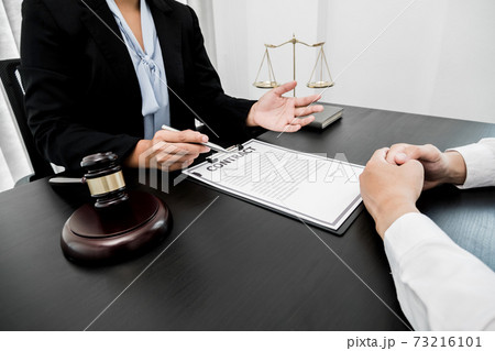 A woman lawyer or a judge counseling clients about judicial justice and prosecution with scales, judges gavel, legal documents legal services concept A woman lawyer or a judge counseling clients about judicial justice and prosecution with scales, judges gavel, legal documents legal services concept 73216101