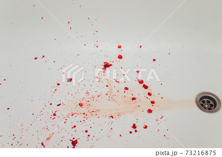 Blood draining from white bathroom basin. Bloody stains in the waterbasin hole. Blood draining from white bathroom basin. Bloody stains in the waterbasin hole. 73216875