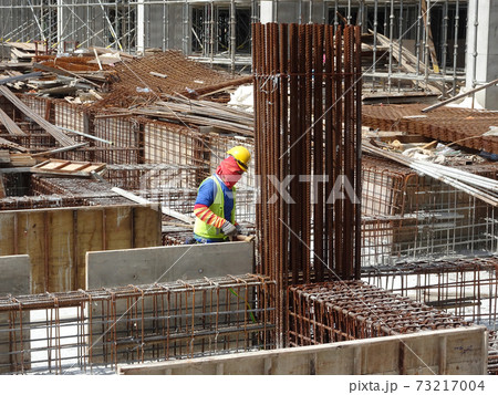 SEREMBAN, MALAYSIA -JULY 15, 2017: Construction workers fabricating timber form work mostly using timber and plywood at the construction site.   73217004