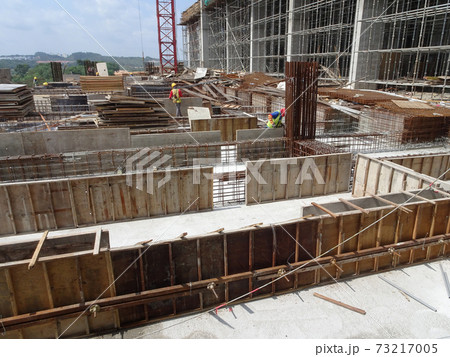 SEREMBAN, MALAYSIA -JULY 15, 2017: Construction workers fabricating timber form work mostly using timber and plywood at the construction site.   73217005