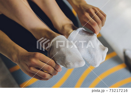 female hand close-up. dirty white socks short supply. 73217216