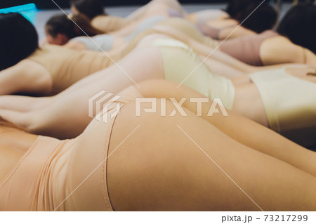 Many girls training in studio ballet, long woman legs ass bracing, wearing sexual flesh color bodysuit. 73217299