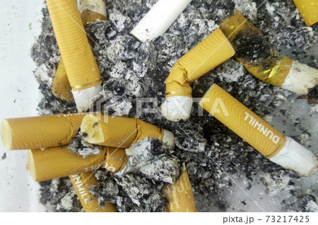 SELANGOR, MALAYSIA -MAY 20, 2017: Used cigarette butt in dirty ashtray. SELANGOR, MALAYSIA -MAY 20, 2017: Used cigarette butt in dirty ashtray. 73217425