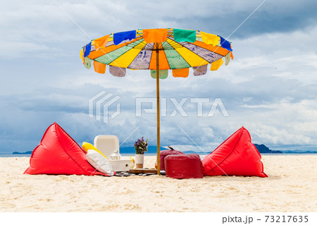 Set comfortable seats with umbrella on the beach. 73217635