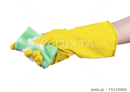 Cleaning concept - hand in a yellow rubber glove holds a green sponge 73218960