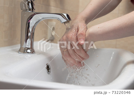 Hygiene. Cleaning Hands. Washing hands with soap. Woman's hand with white soap and foam. Protect yourself from coronavirus COVID-19 pandemia. 73220346