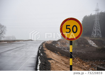 Speed limit road sign on a road under construction Speed limit road sign on a road under construction 73220859